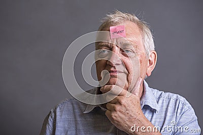 Mature man with an urgent note on his forehead Stock Photo