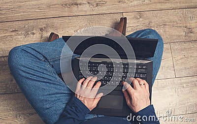 Mature man using laptop computer. Male hands typing on laptop keyboard. Business working, freelance or remote work concept. Stock Photo