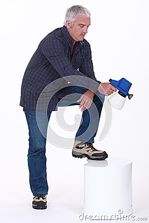 Mature man using sprayer Stock Photo