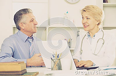 Mature man visits doctor Stock Photo