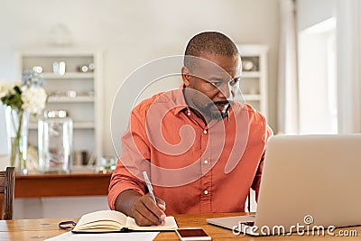 Mature man working on laptop at home Stock Photo