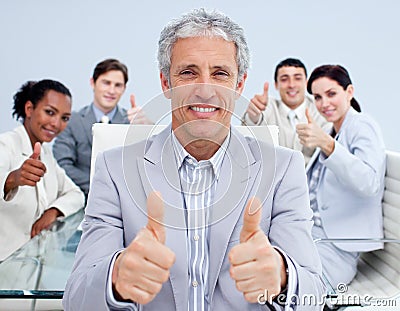 Mature manager celebrating a sucess with his team Stock Photo