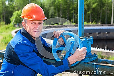 Mature manual worker with stop-gate valve Stock Photo