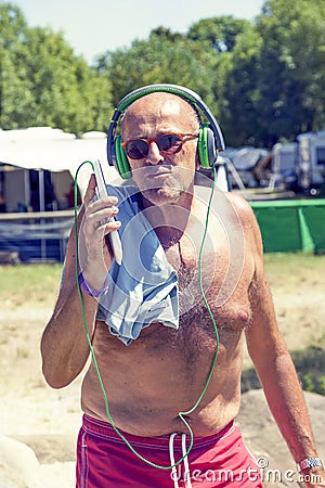 Mature modern man listens to music with headphones Stock Photo