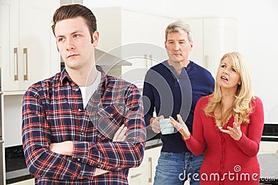 Mature Parents Frustrated With Adult Son Living At Home Stock Photo