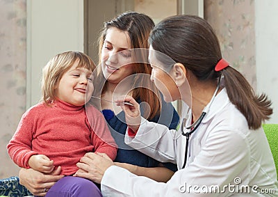 Mature pediatrician examining 2 years child Stock Photo