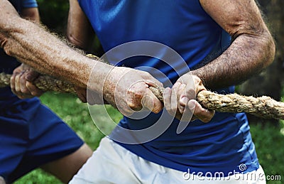 Mature people in tug of war Stock Photo