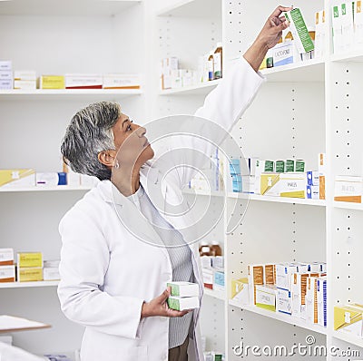 Mature pharmacist woman, shelf and boxes with thinking, packing stock and inventory inspection. Senior pharmacy manager Stock Photo