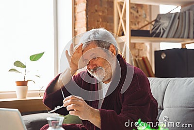 Mature senior older man during quarantine, realizing how important stay at home during virus outbreak, suffers of Stock Photo