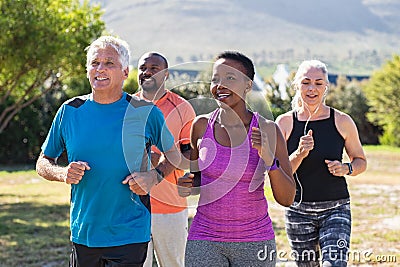 Mature and senior people jogging at park Stock Photo