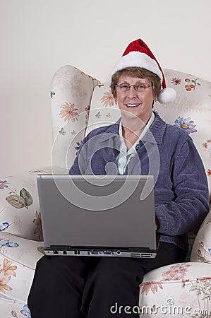 Mature Senior Woman Christmas Laptop Santa Hat Stock Photo