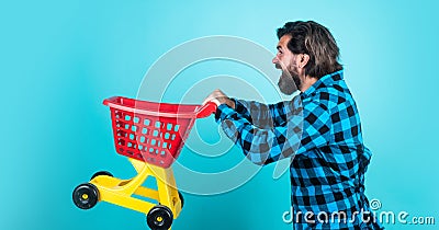 mature shopper go shopping in mall. bearded man carry shopping cart. brutal guy making purchase. male fashion style Stock Photo