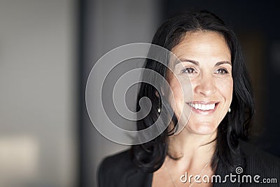 Mature Spanish Businesswoman Smiling And looking Away. Stock Photo