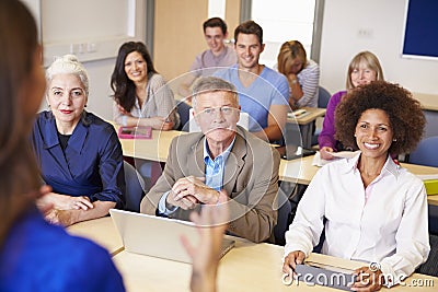 Mature Students In Further Education Class With Teacher Stock Photo