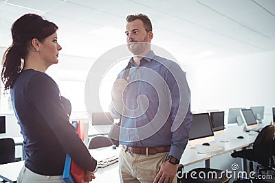 Mature students interacting with each other in the computer room Stock Photo