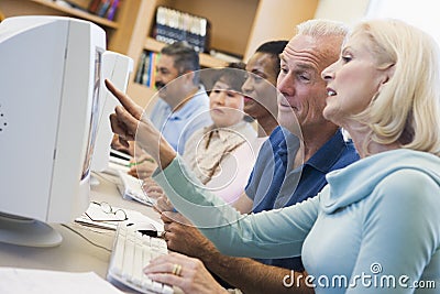 Mature students learning computer skills Stock Photo