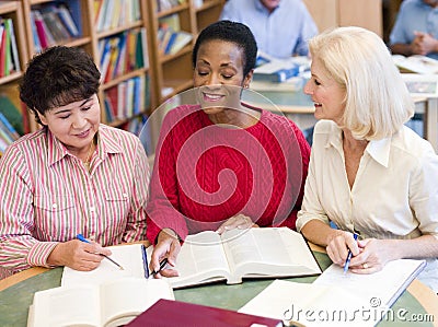 Mature students studying in library Stock Photo