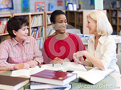 Mature students studying in library Stock Photo