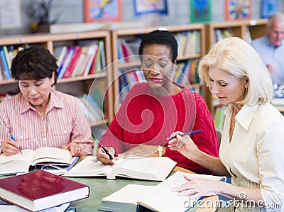 Mature students studying in library Stock Photo