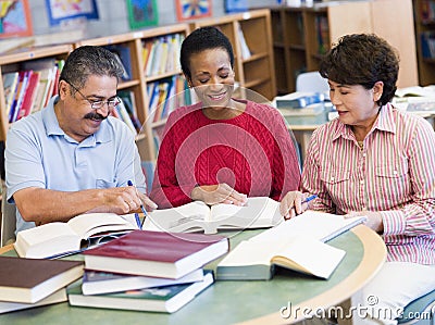 Mature students studying in library Stock Photo