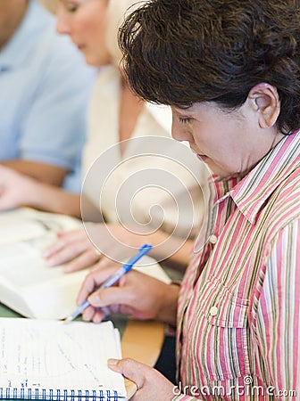 Mature students studying in library Stock Photo