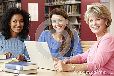 Mature students working in library Stock Photo