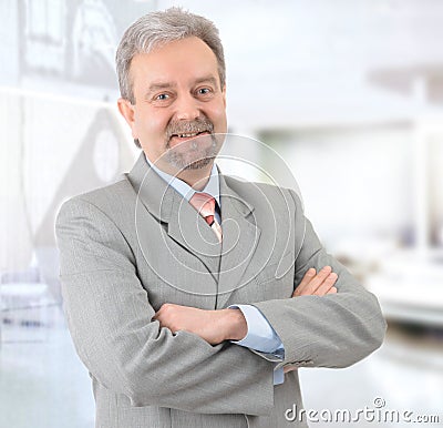 Mature successful businessman smiling and looking Stock Photo