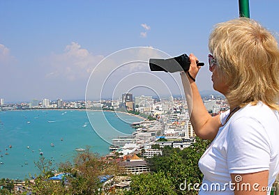 Mature woman with camera. Pattaya View of Pattaya viewpoint from Pratumnak Hill Stock Photo