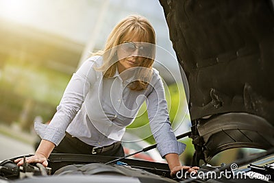 Mature woman with car trouble Stock Photo