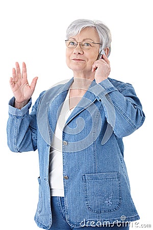 Mature woman chatting on mobile smiling Stock Photo