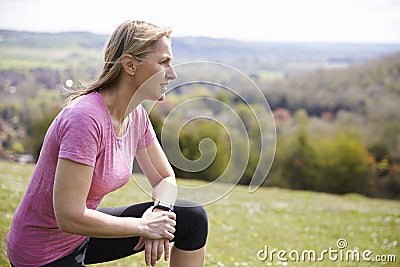 Mature Woman Checking Activity Tracker Whilst On Run Stock Photo