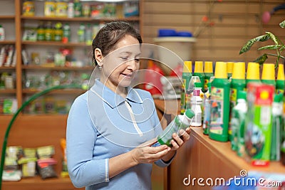 Mature woman chooses agricultural chemistry Stock Photo