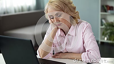 Mature woman falling asleep at workplace, lack of vitamins and energy, tired Stock Photo