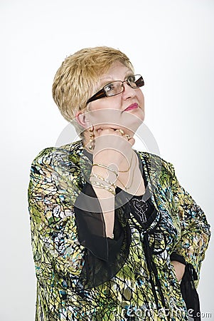 Mature woman with glasses thinking Stock Photo