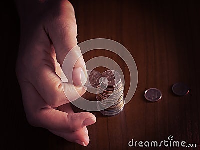 Mature, woman hand putting coins into a pile, heap, on white tablecloth background. Close. European euro coins, counting Stock Photo