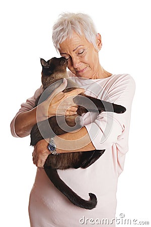 Mature woman holding cat in her arms Stock Photo