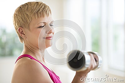 Mature Woman Lifting Weights Stock Photo