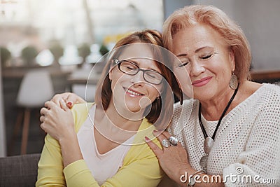 Mature woman meeting her senior mother at the coffee shop Stock Photo