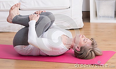 Mature woman practicing pilates Stock Photo