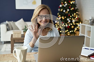 Mature woman saying hello during a videoconference Stock Photo