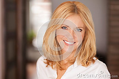 Mature woman smiling at the camera. She relaxing at home. Beautiful Stock Photo