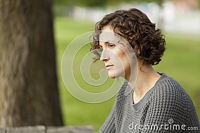 Mature woman thinking at the park Stock Photo