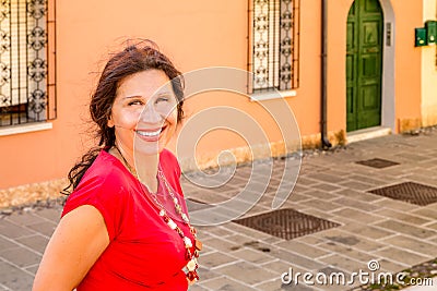 Mature woman in typical town in Italy Stock Photo