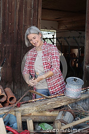 Matured farm woman at work Stock Photo