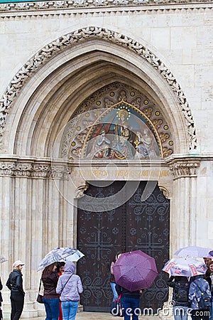 Matyas-templom or Matthias Church on Castle Hill in Buda Castle District, entrance door with tourists Editorial Stock Photo