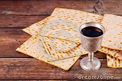 Matzah and a silver cup full of wine. Jewish holidays concept Stock Photo