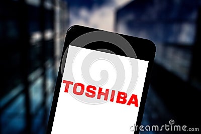 May 17, 2019, Brazil. In this photo illustration the Toshiba Corporation logo is displayed on a smartphone Cartoon Illustration