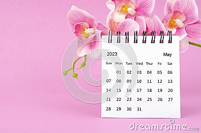 The May 2023 calendar desk and pink orchid on pink background Stock Photo