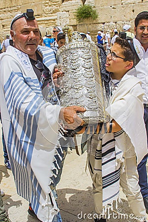 A Father and Son carry a Sefer Torah Case at his Bar Mitzvah in Editorial Stock Photo