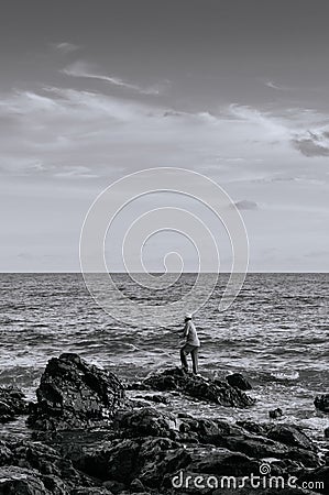 Local fisherman with fishing rod at Nui beach on Koh Lanta, Krabi, Thailand Editorial Stock Photo